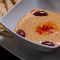 Hummus · Chickpeas and Tahini.  Served with Pita Chips.
