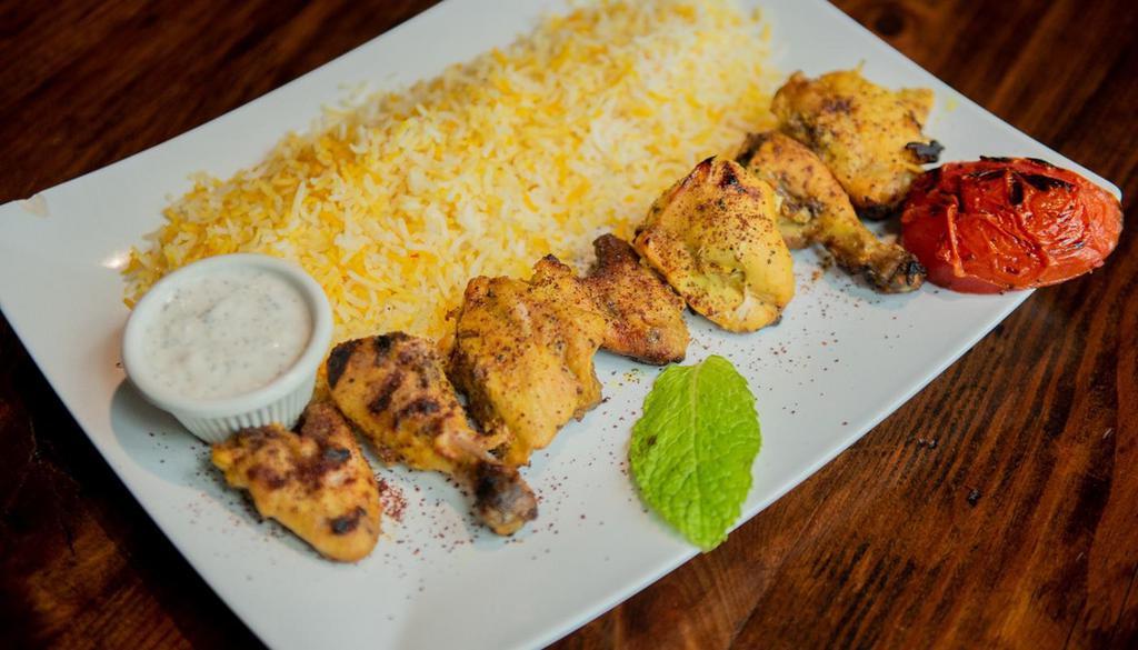 Joojeh · A skewer of lemon marinated cornish hen seasoned with saffron. Served with saffron rice.