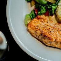 Baked Salmon · A filet of salmon baked and served with rice and mixed vegetables.