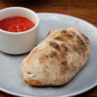 Calzone · homemade ricotta cheese & three fillings from the toppings list below, . served with side of...