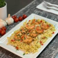 Shrimp Fettuccine · Sauteed shrimp served over fresh fettuccine in a light garlic cream sauce.