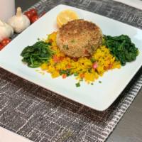 Maryland Crab Cakes · Fresh handcrafted crab cakes served over chef's yellow rice and broccoli.
