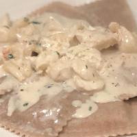 Butternut Squash Ravioli · In a bechamel champagne sauce with crabmeat. Served with garlic bread. Optional side salad f...
