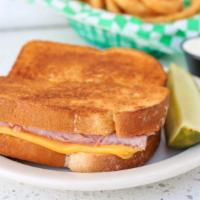Grilled Ham & Cheese · Made with American cheese on white bread served with a pickle wedge.