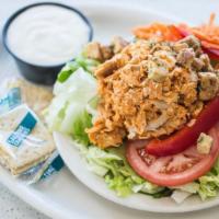 Wishbone Buffalo Chicken Salad · Our pan-fried chicken shredded in buffalo sauce on a bed of iceberg and romaine lettuce topp...