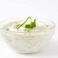 Tzatziki · Creamy yogurt dip made with cucumbers, garlic, and lemon juice, served with pita chips.