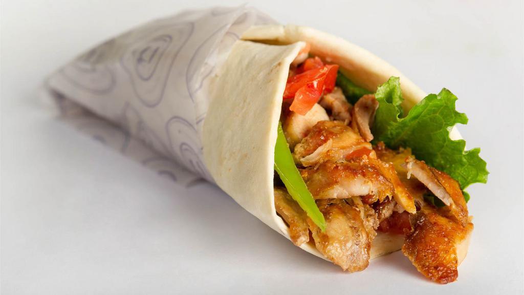 Chicken Shawarma Wrap · Thin juicy slices of chicken with lettuce, tomato, onions and tzatziki sauce, served on pita bread.