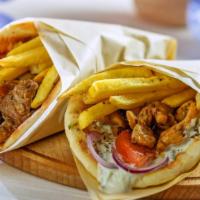 Lamb Shawarma Wrap · Thin juicy slices of lamb with lettuce, tomato, onions and tzatziki sauce, served on pita br...