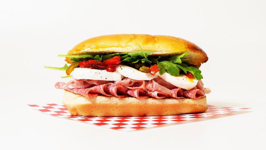 The Godfather Sub · Prosciutto, capicola, salami, mozzarella, arugula, and roasted red peppers on a hoagie roll.