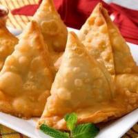 Vegetable Samosa Vegan , Contain Gluten · 2 piece. Spiced potatoes and green peas turnovers. Served with tamarind and mint sauce.