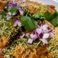 Samosa Chaat Vegetarian , Contain Dairy & Gluten · Potato and pea turnover topped with spiced chickpeas, yogurt, cilantro, mint sauce, and tama...