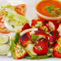 Chicken Tikka Halal , Gluten Free , Contain Dairy · Chicken breast pieces marinated in yogurt and spices. Served with salad, makhani sauce, and ...