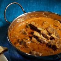 Goat Curry · Baby goat slow cooked in onion, tomato, ginger and garlic sauce with chef's special spices. ...