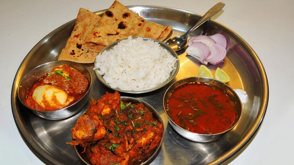 Chicken & Meat Combo Platter · Choice of 1 chicken entree and 1 meat entree. Served with basmati rice and 2 made-to-order tandoori roti or naan bread.
