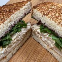 Grilled Turkey & Brie Sandwich · Turkey, brie, arugula, blackberry jam on toasted whole grain bread