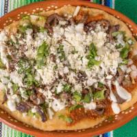 Garnacha · Homemade masa dish stuffed with refried beans and topped with choice of protein, onion, cila...