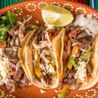 Tacos De Alambre · Three speciality fajita style taco with grilled bacon, chicken OR steak, peppers, tomato, on...