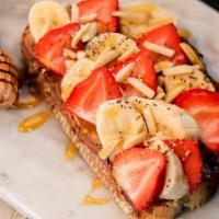 Toasted Nut Toast · almond butter, nutella, banana, strawberry, almond, chia seeds & drizzles with honey