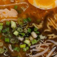 Shoyu Black & Red Wavy Noodle · Spicy dark soy sauce ramen pork chashu, egg, green onion and bean sprouts.