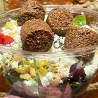 Falafel Salad · Four falafel balls served over a bed of mixed greens, tomato, cucumber, pickle, feta cheese,...
