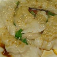 Steamed Dumpling · Homemade dumplings filled with chicken, onions, and scallions, served with a soy-ginger sauce.
