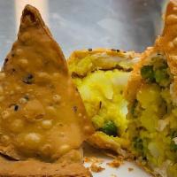 Veggie Samosa · Fried cone shaped pastry with savory potatoes, onions and peas filling.
