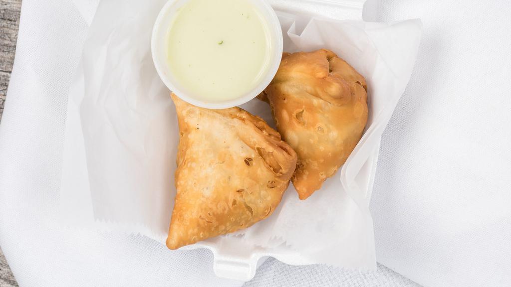 Vegetable Samosa · Two crispy fried turnovers filled with potatoes and peas.