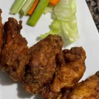 Mango Habanero Wings · Fried chicken wings tossed in our homemade Mango Habanero sauce,