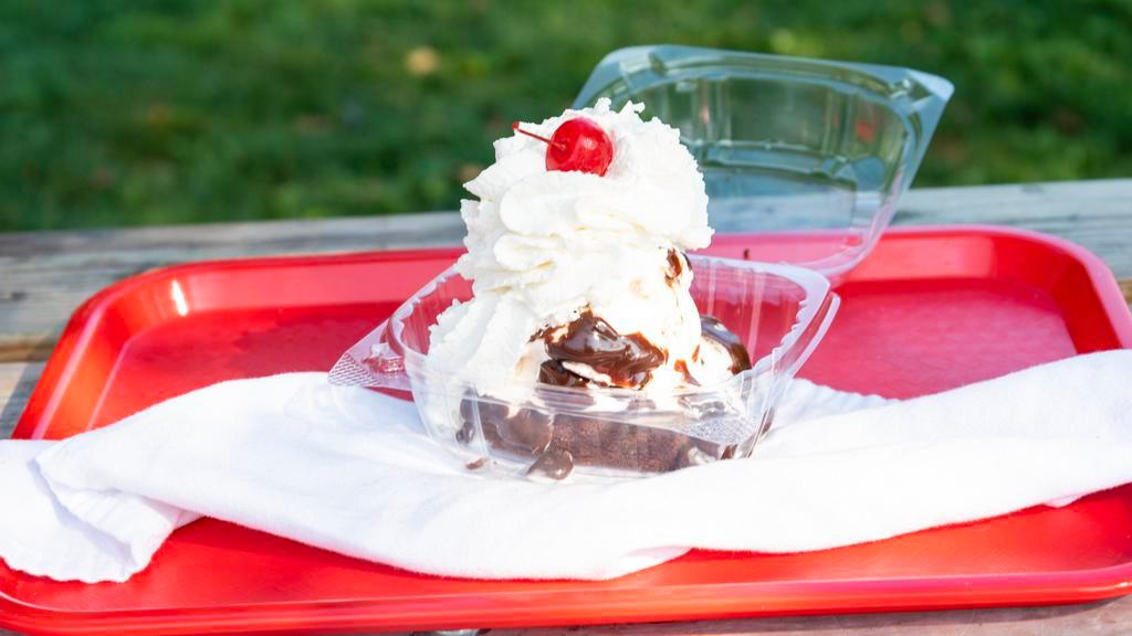 Hot Brownie Fudge Sundae · A hot brownie, topped with your choice of ice cream, hot fudge. Includes whipped cream and a cherry.
