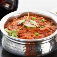 Baingan Bharta · Smoky roasted eggplant in a slow cooked stew of tomato and onion with mustard seeds, garam m...