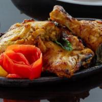 Tandoori Chicken · Bone-in chicken stepped in yogurt and mustard oil marinade with garam masala, chili, cumin a...