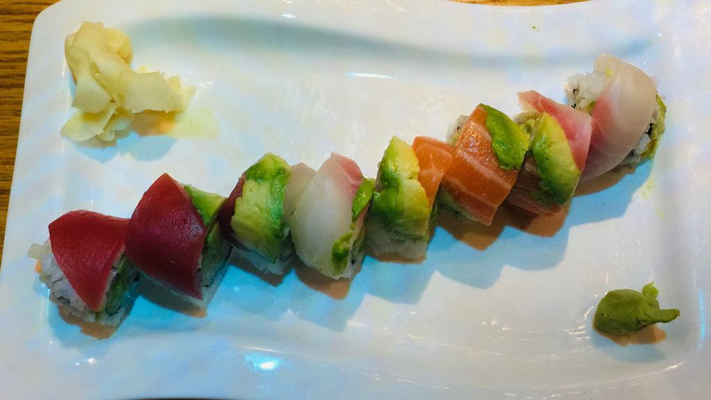 Rainbow Roll · Crab, cucumber and avocado inside with raw fish outside.