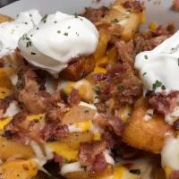 Loaded Steak Cut Fries · Thick steak cut fries loaded with bacon, mozzarella cheese, cheddar cheese, and ranch.