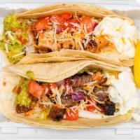 2 Tacos Combo · Make combo with two tacos, rice, black or pinto beans, tortilla chips, and can soda.
