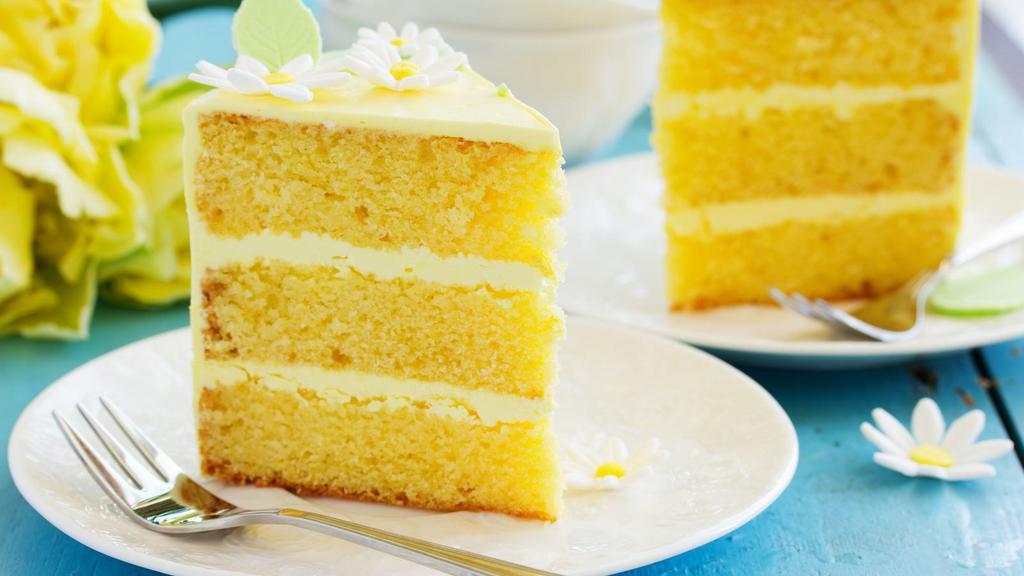 Lemon Cake · A slice of our fresh made tender lemon sponge cake.