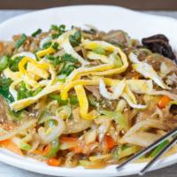 Japchae · Stir-fried clear noodles with pork and vegetables.