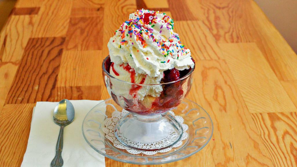 Strawberry Shortcake Sundae · Warm yellow cake, topped with two scoops of vanilla ice cream, strawberry topping, whipped cream and rainbow sprinkles.