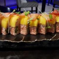 Tropical King Maki · Shrimp tempura and cucumber wrapped in soybean paper, topped with king crab salad, diced man...