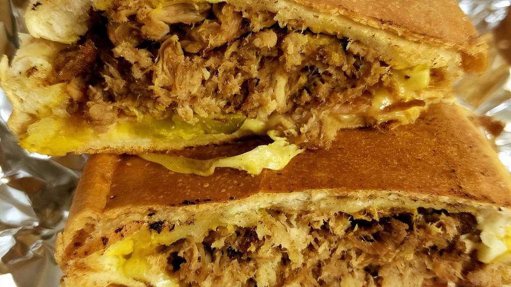 Cubano Sub · Roasted pork, ham, pickles, mustard, and Swiss cheese.