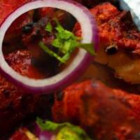 Tandoori Chicken · A whole/full roasted chicken marinated in yogurt and generously spiced.