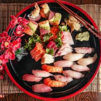 Treasure Boat (For 3) · 12 pieces of sushi, 18 pieces of sashimi, one dragon roll, one rainbow roll, and one spicy t...