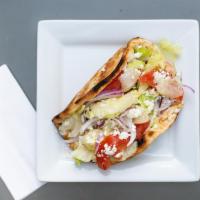 Chicken Souvlaki Pita · Grilled marinated chicken skewer on pita bread, topped with lettuce, tomatoes, red onions, f...