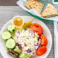 Athena Greek · A bed of romaine lettuce topped with tomatoes, cucumbers, red onions, feta cheese, Greek (ka...