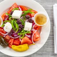 Hortiatiki Village Salad · Tomatoes, cucumbers, feta cheese, red onions, bell peppers & olives. Dressed with olive oil ...