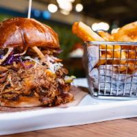 Motley Que Pulled Pork · Pulled pork shoulder smothered in Guy's bourbon brown sugar BBQ sauce, stacked with citrus s...
