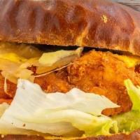The Delco · Crispy Chik'n Sandwich w/ American Cheese, Fried Onions, Dijon Mustard served on a Pretzel Bun
