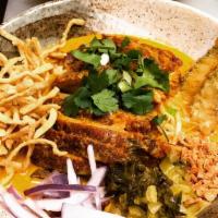 Khao Soi · Thai curry, red onion, pickle, hot chili oil, lime, crispy egg noodle and egg noodle. Topped...