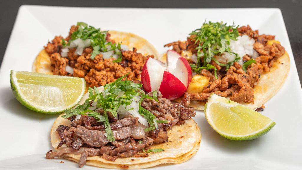 Bistec Tacos · Steak tacos. Topped with onion and cilantro.