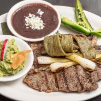 Carne Asada · Sirloin grilled steak. Served with cactus salad, spring onion, jalapeño, guacamole and beans.