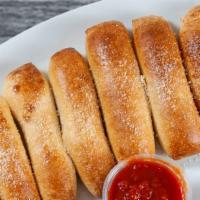 Homemade Breadsticks · Fresh baked breadsticks topped with garlic butter and parmesan cheese, served with marinara.